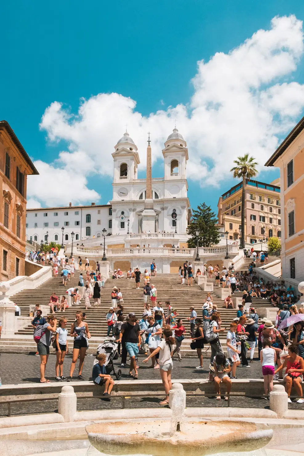 Spanish Steps in Rome crowded with visitors near the fountain at the base