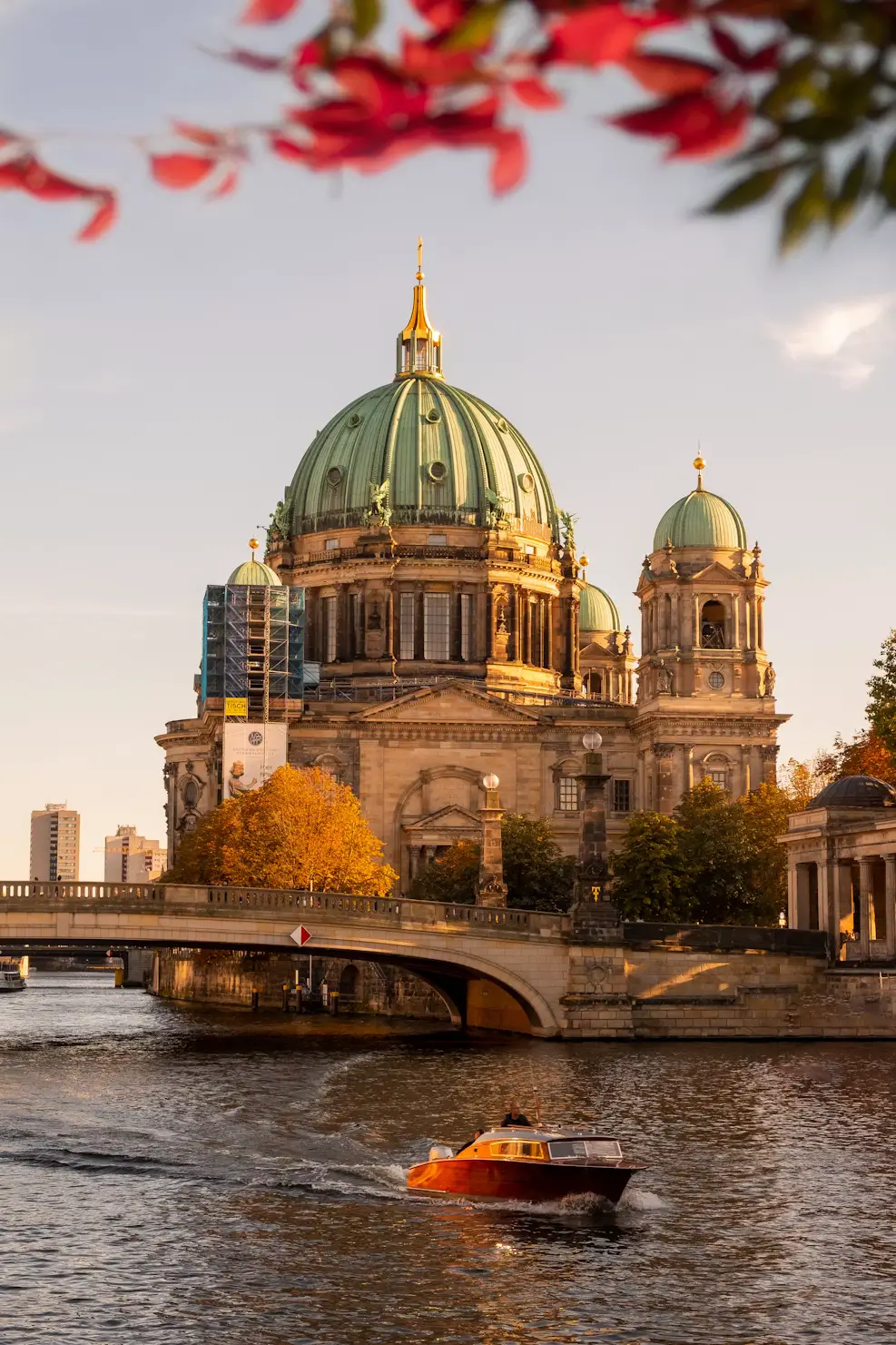 Berlin Cathedral viewed across the river with a bridge and boat in the foreground