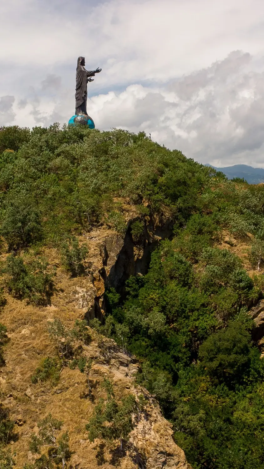 Cristo Rei of Dili statue on hilltop overlooking Timor-Leste coastline