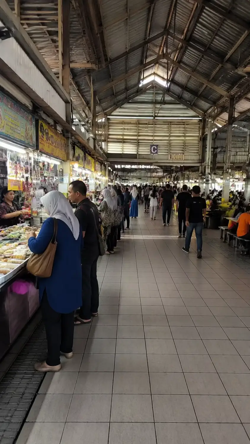 Busy indoor covered food market with local vendors and shoppers, Gadong night market, Bandar Seri Begawan, Brunei