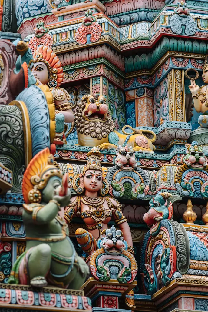 Colorful, intricately carved Hindu temple facade featuring detailed sculptures of deities and figures in Sri Lanka.