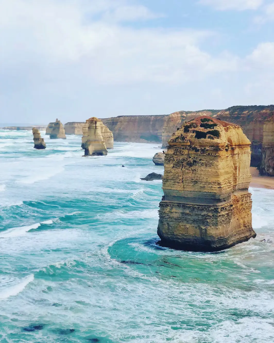 Close-up view of the Twelve Apostles rock formations with crashing waves, Victoria, Australia