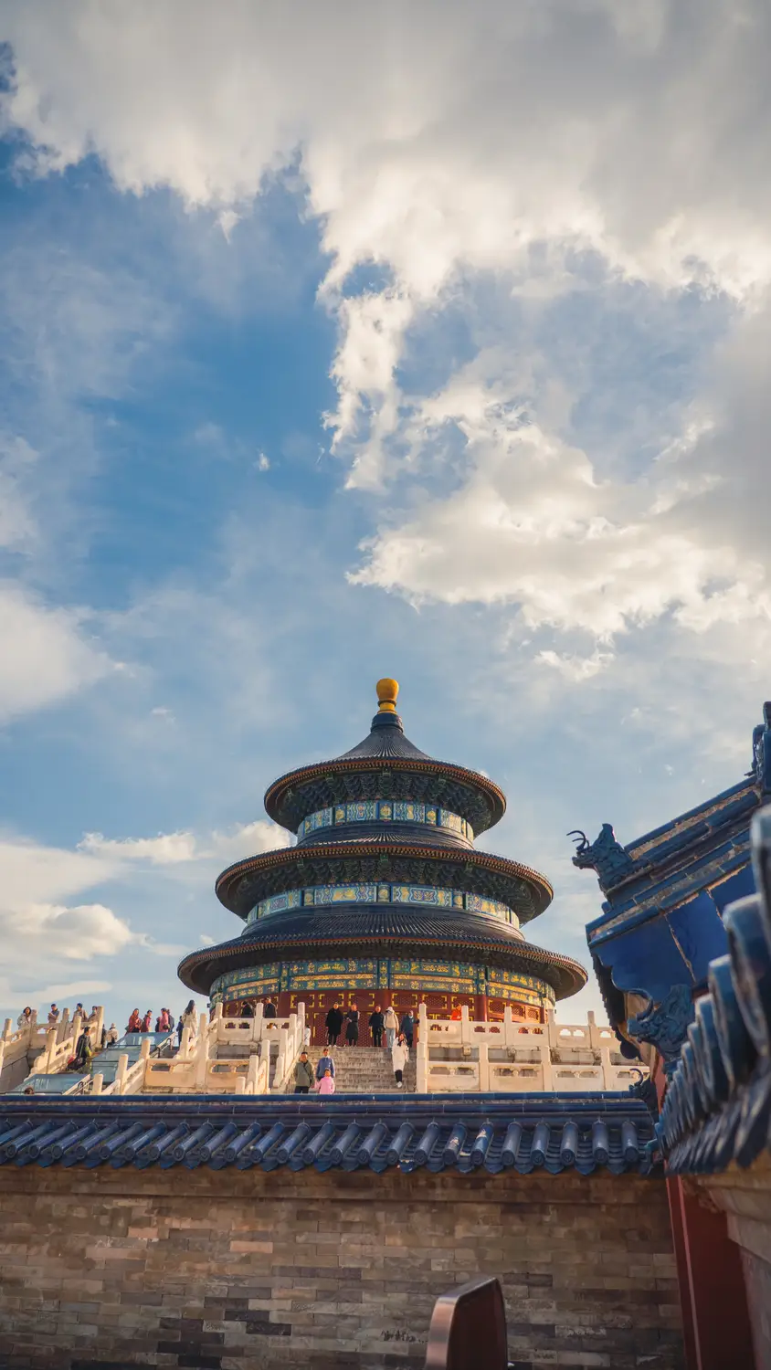 Temple of Heaven Hall of Prayer for Good Harvests with ornate blue triple-tiered roof under blue sky, Beijing China