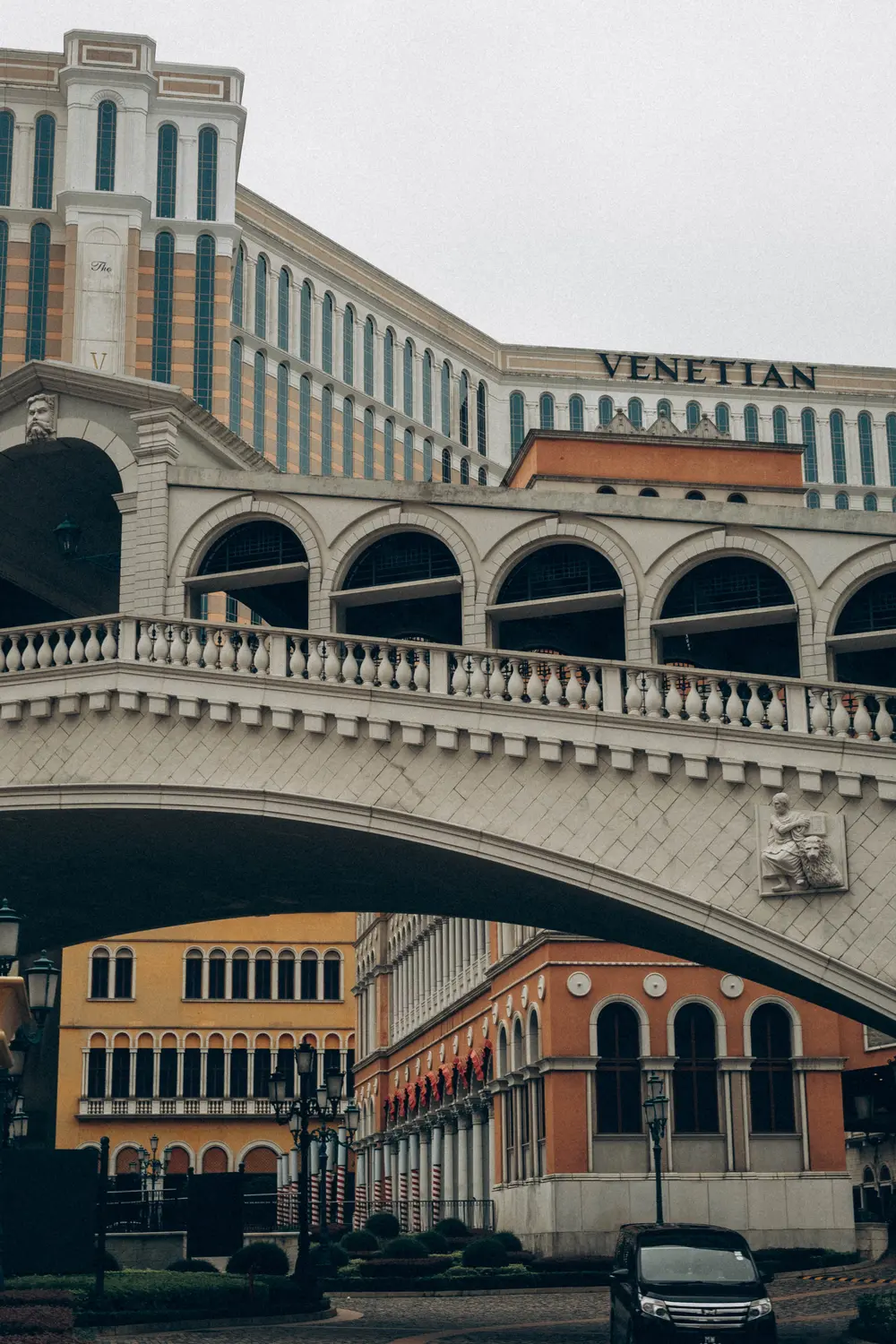 Arched colonnade bridge with Mediterranean-style architecture at The Venetian Macau