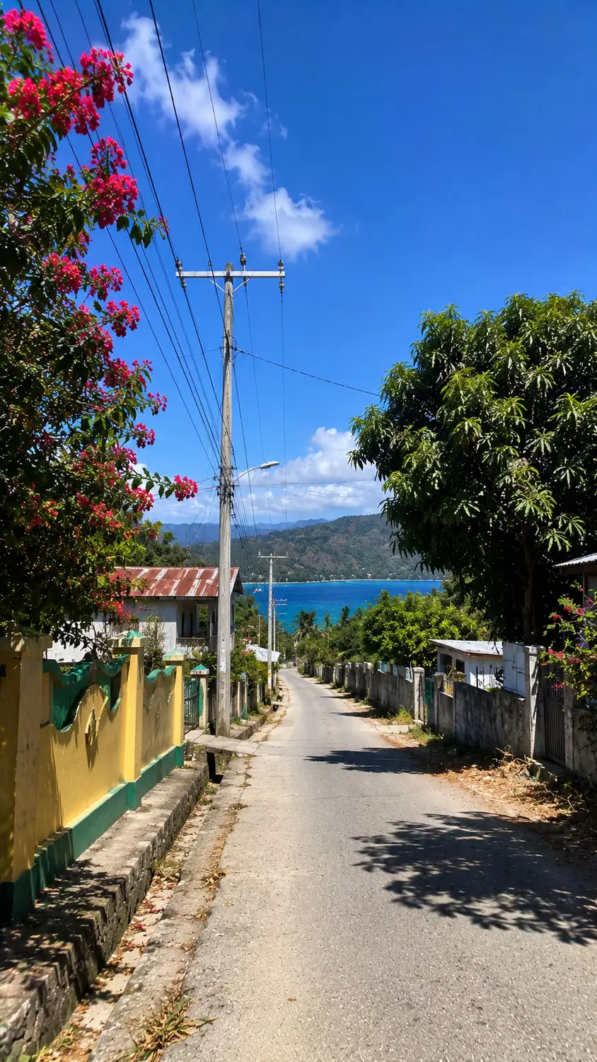 Colorful village street with flowering trees and ocean view Timor-Leste
