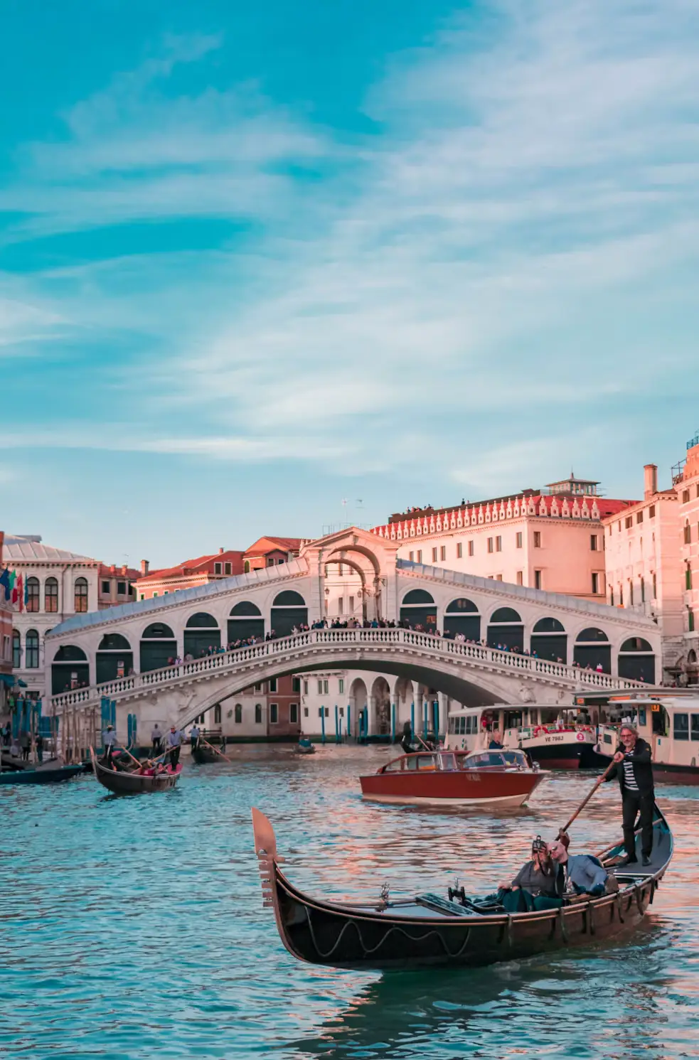 Gondola gliding past the Rialto Bridge on the Grand Canal in Venice