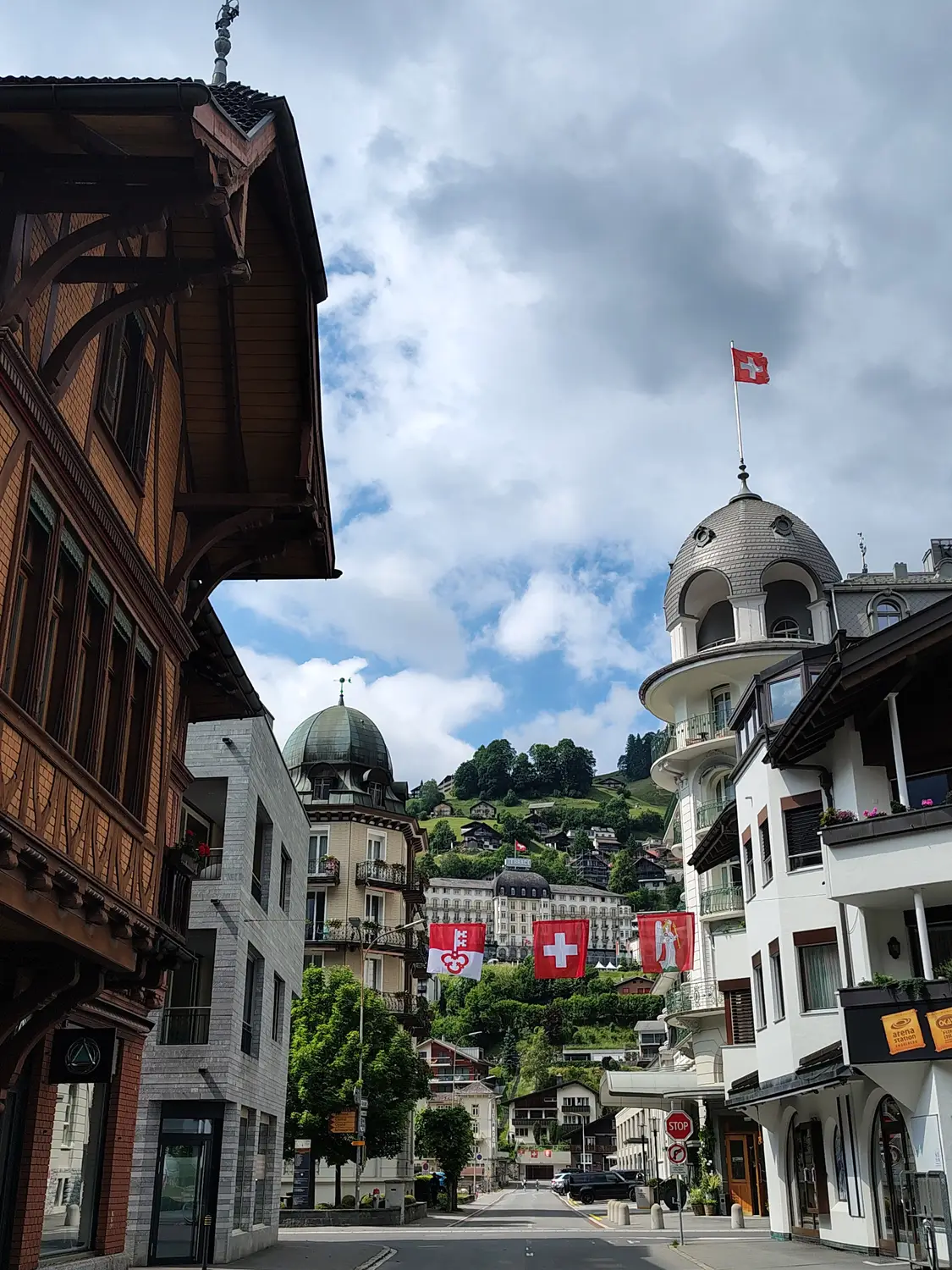 Pedestrian street lined with traditional buildings and a Swiss flag, Switzerland