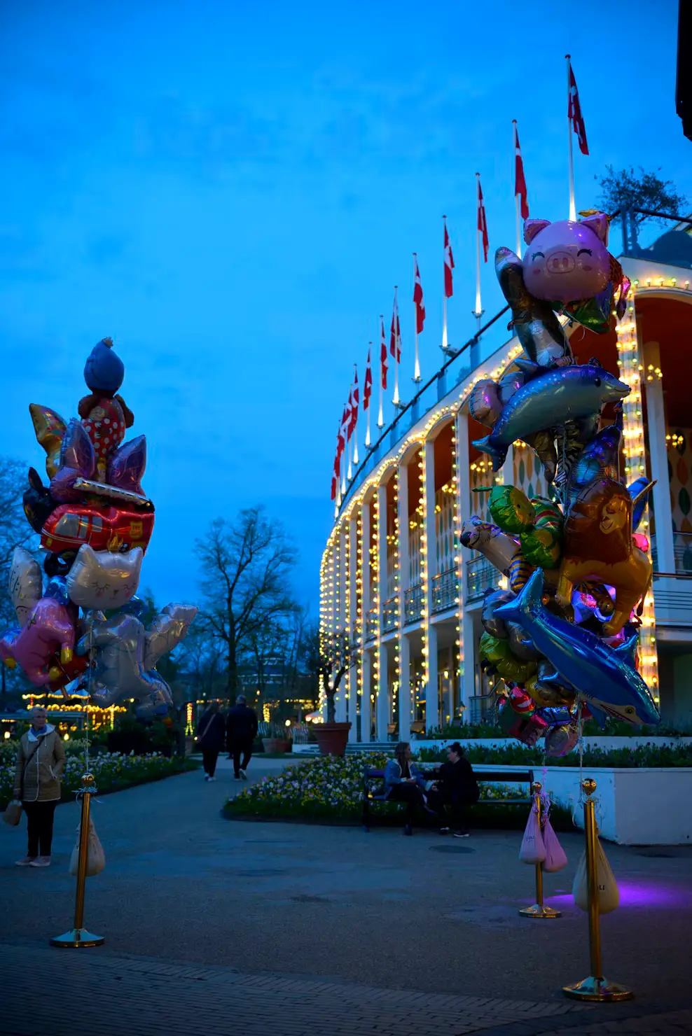 Tivoli Gardens illuminated at night with festive lights and colorful decorations