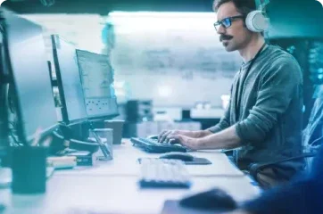 Man working at a desk with headphones on