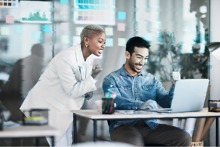 Coworkers looking at laptop