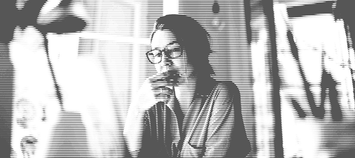 Woman with glasses on looking at a computer screen
