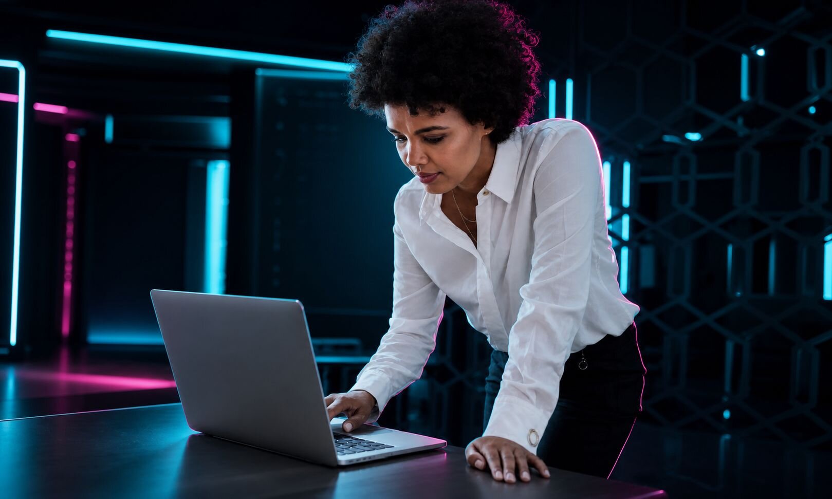 Woman standing in front of a laptop on a desk