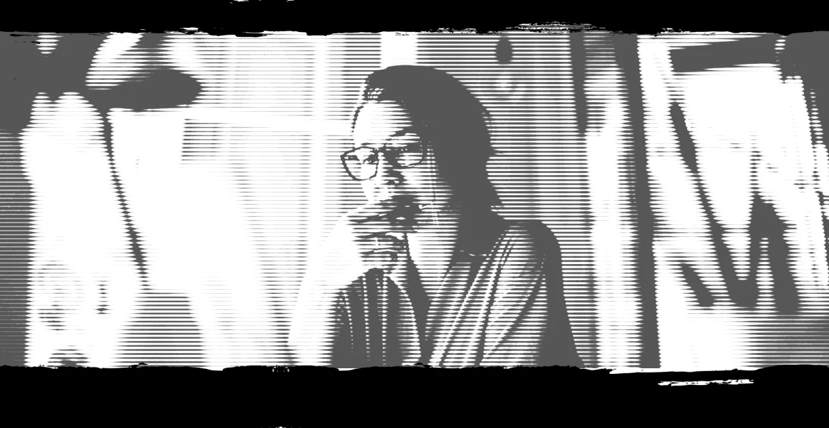 Woman with glasses on looking at a computer screen