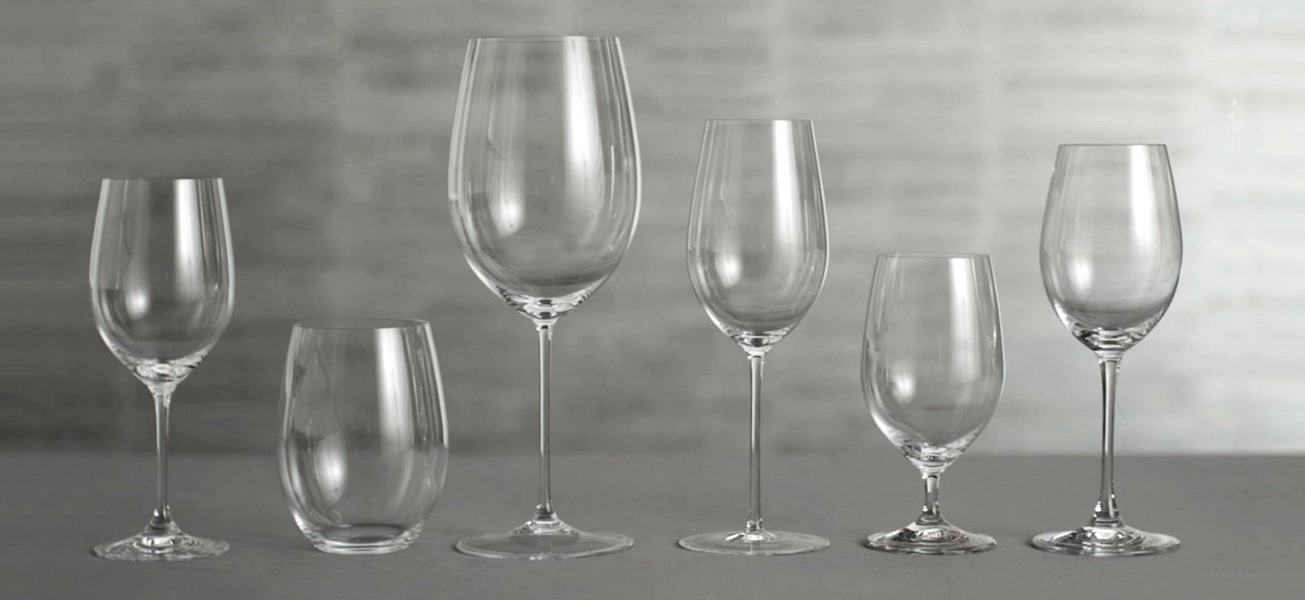 A stone-colored table displays six different types of stemware. 