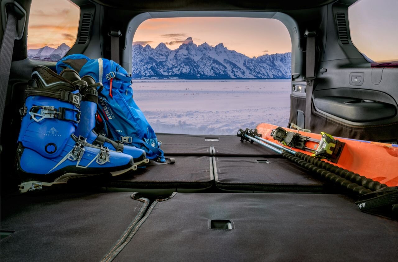 Canvasback cargo liner installed inside a vehicle with back hatch open to snowy mountain scenery