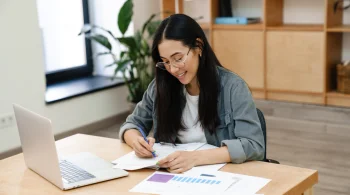 A woman checking on laptop regarding the differences between simple trust vs complex trust