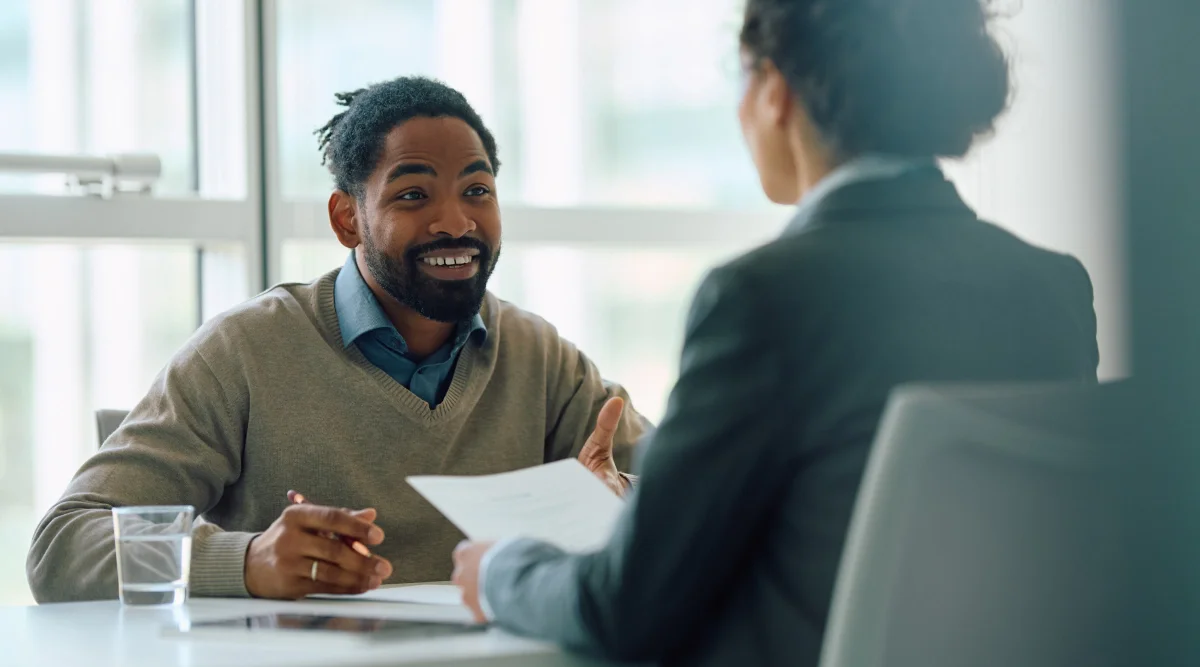 Man smiling during a meeting with a colleague