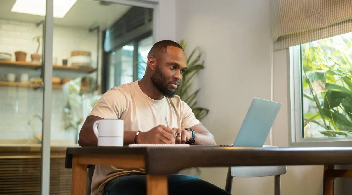 Man working on a laptop in a cozy kitchen