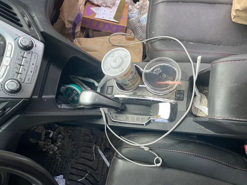 Vehicle center console before interior detailing