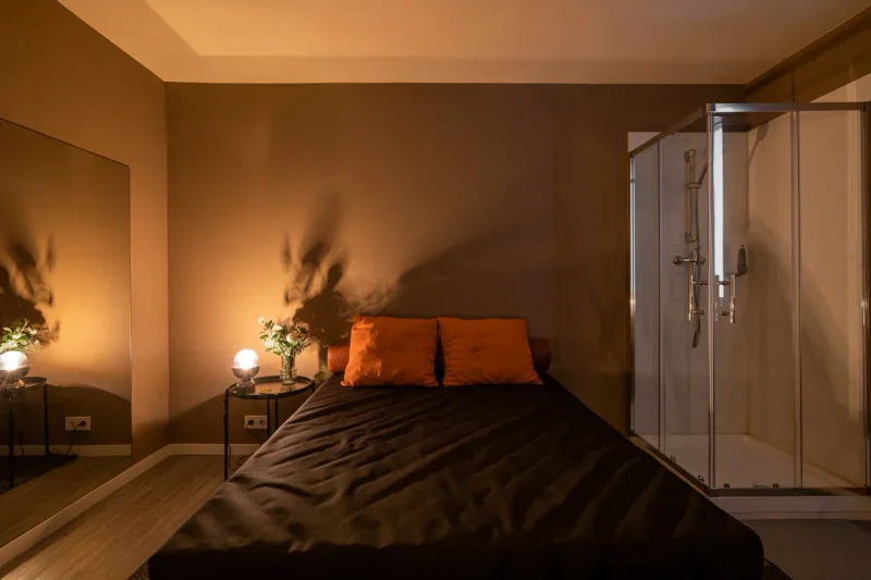 Red silk accents and mood lighting in the massage suite