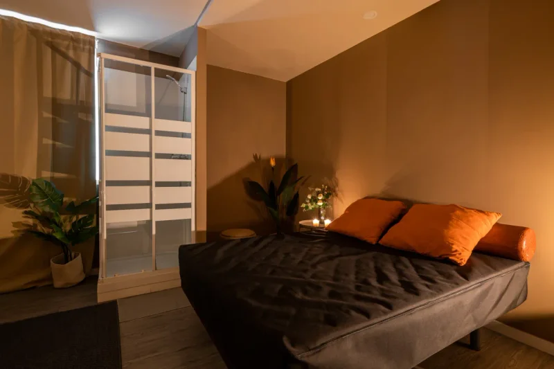 Private massage room with dark wood and soft textiles