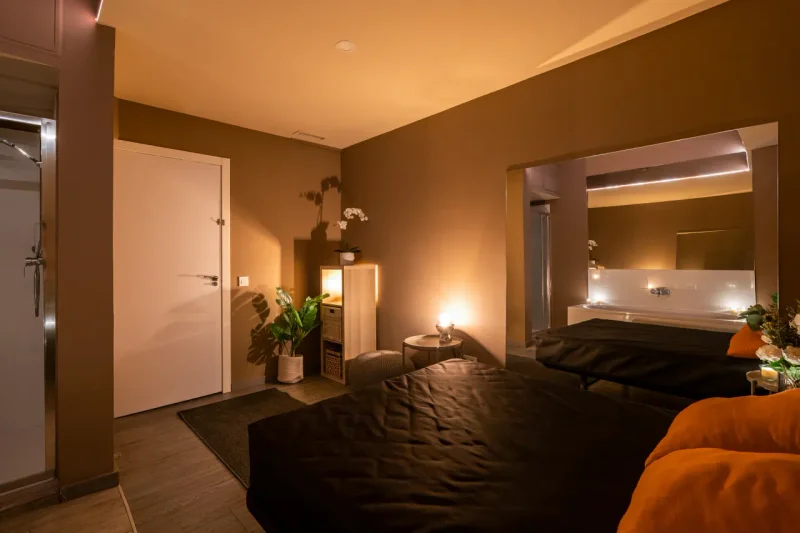 Massage table prepared with premium linens in a candle-lit room