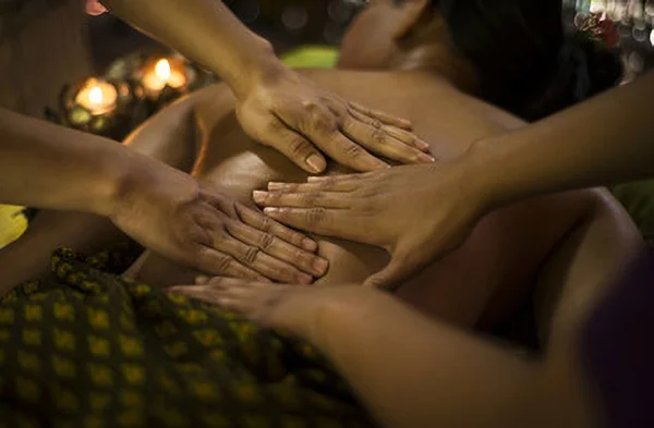 Two therapists performing a synchronized four-hands erotic massage at Stimulos Barcelona