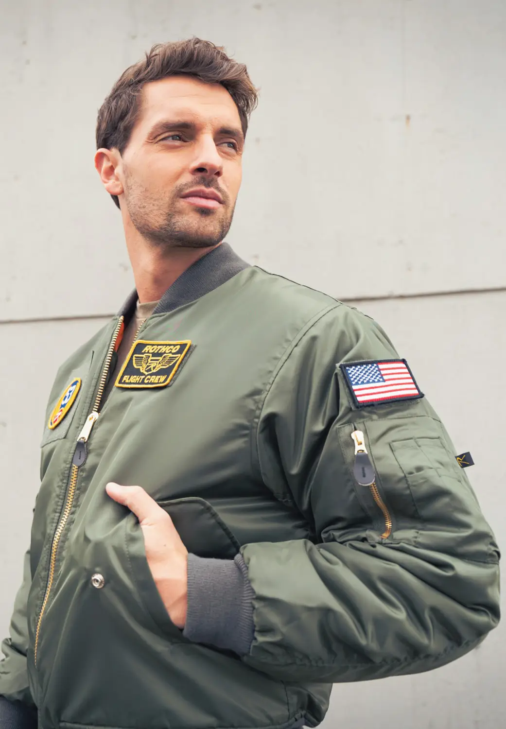 Man in green bomber jacket with patches