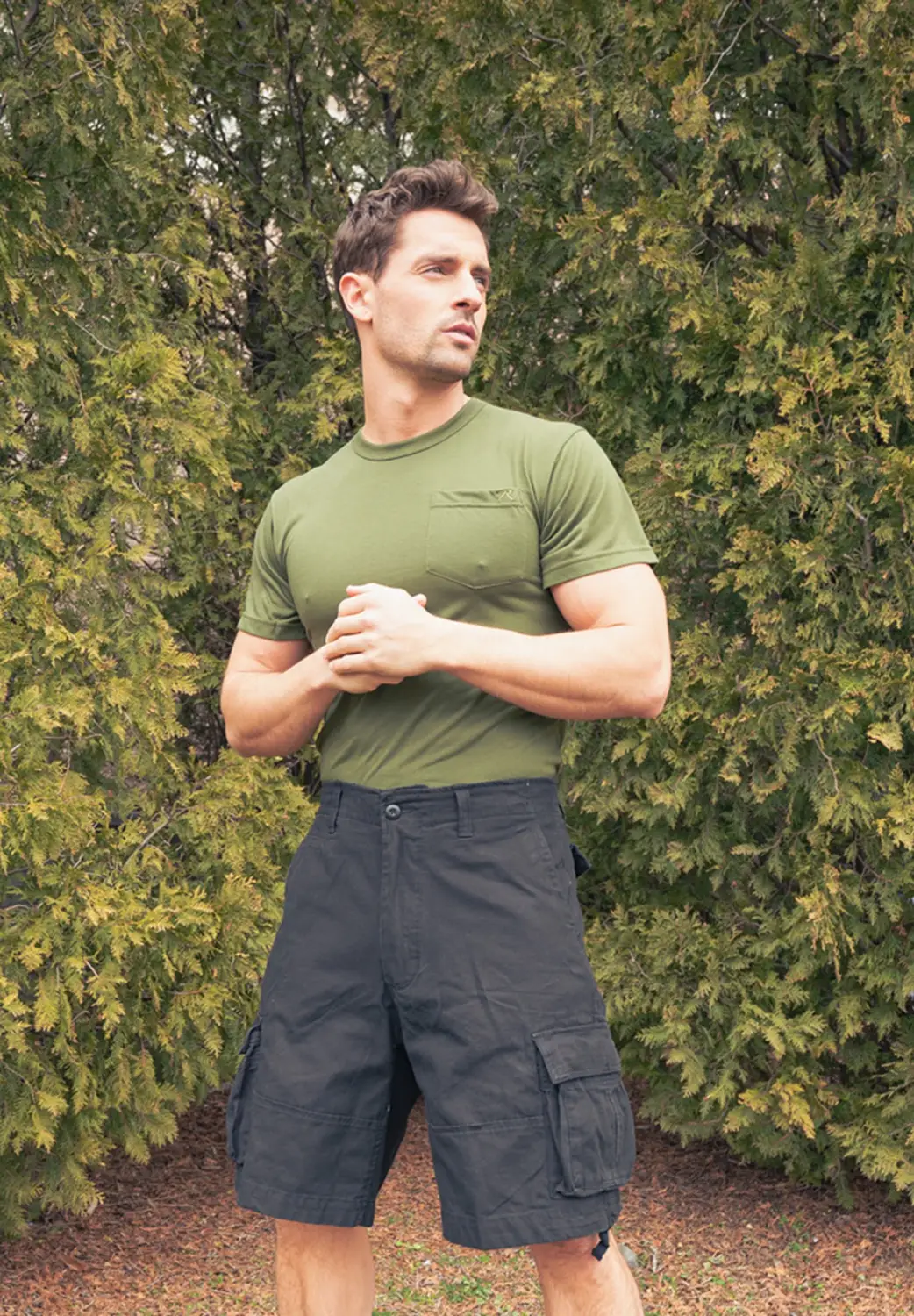 man in green t-shirt and black shorts outside