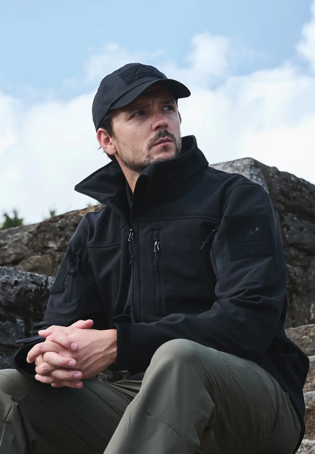 Two Men Wearing Casual Travel Jackets Sitting On Bench