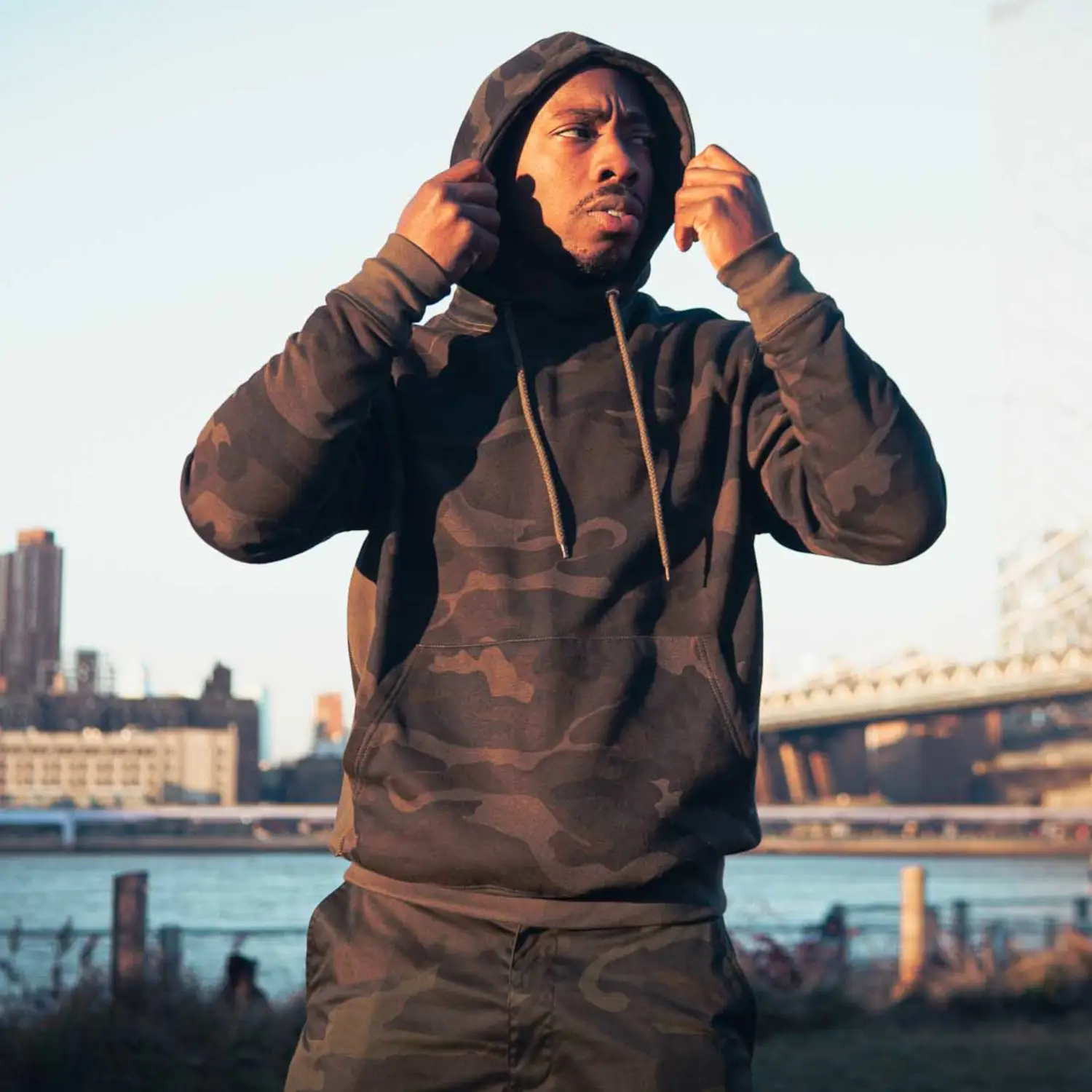 Man Wearing Midnight Black Camo Hoodie Outside