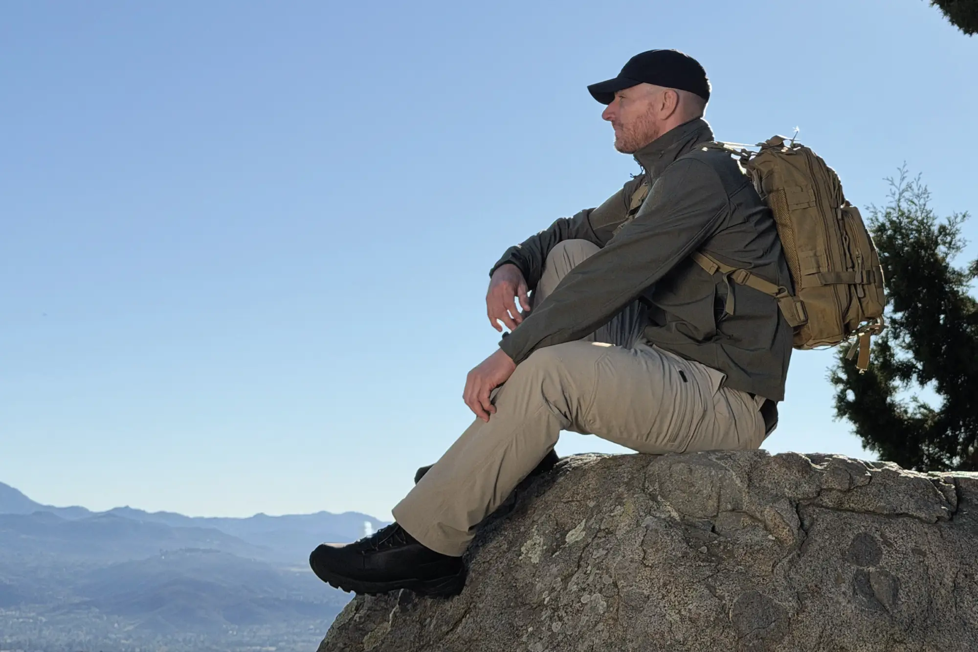 Man Sitting Outdoors on Rock