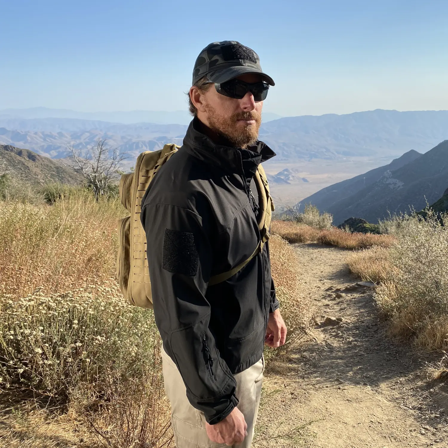 Man Wearing Tactical Jacket on Mountain