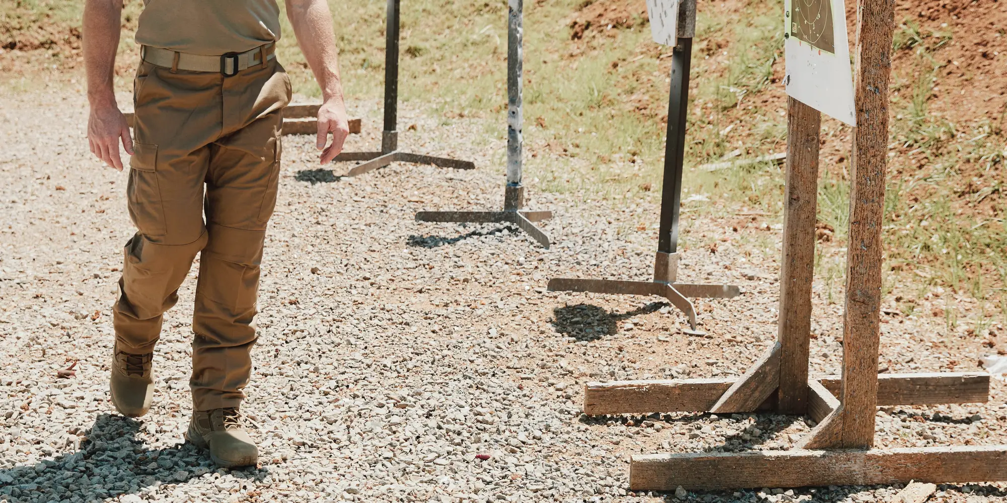 Man walking by shooting ranger targets