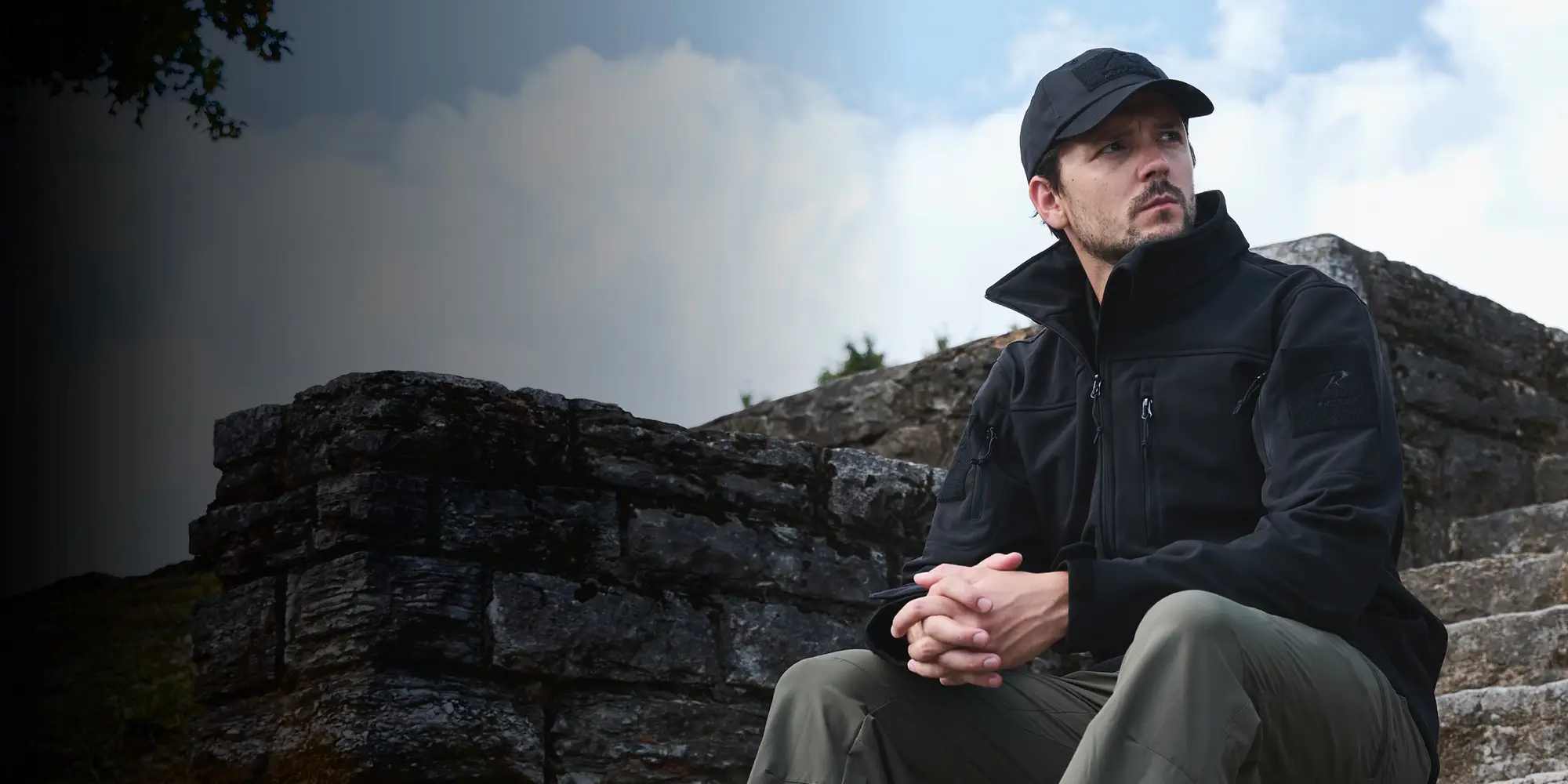 Two Men Wearing Casual Travel Jackets Sitting On Bench