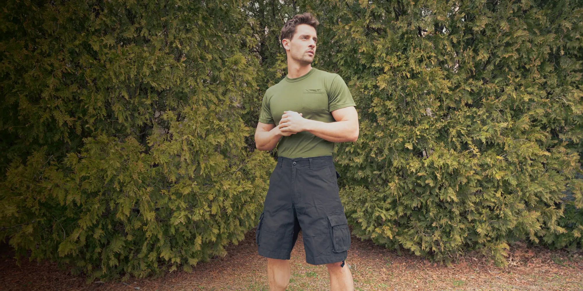 man in green t-shirt and black shorts outside