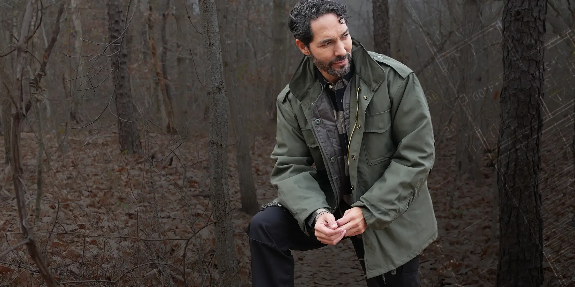 Man Wearing Woobie Jacket Outdoors with Graphic Overlay