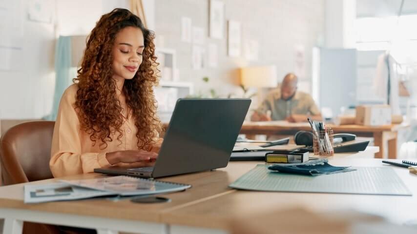 A woman working on her Shopify store's email marketing campaign.