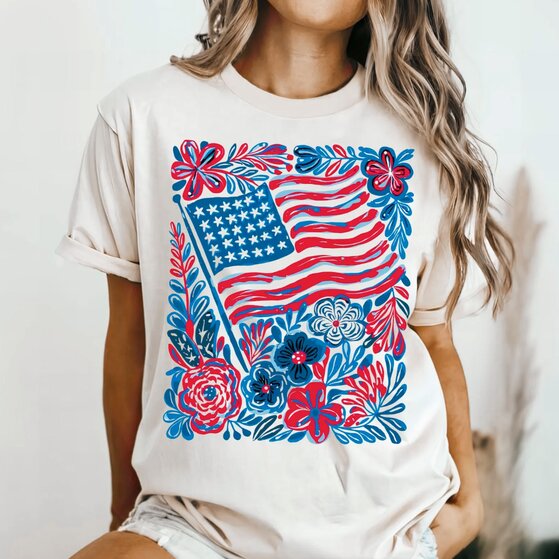 A cream-white 4th of July-themed t-shirt with various icons.