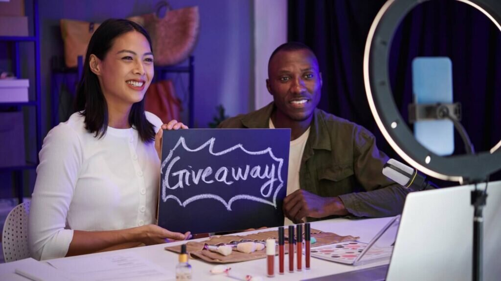 A man and a woman recording a sponsored giveaway segment for their podcast.