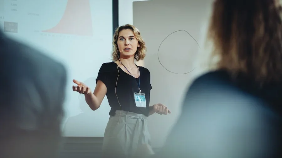 A woman speaking in front of a crowd.