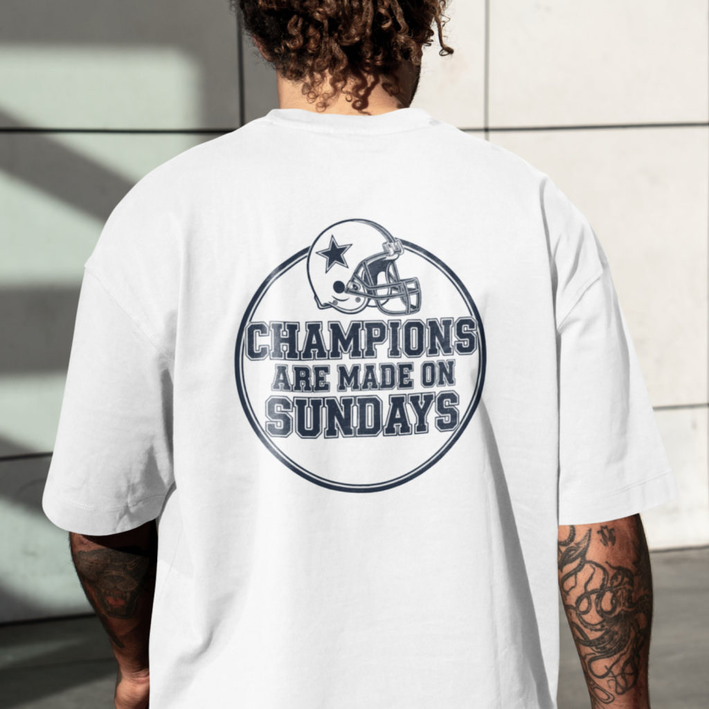 A man wearing a white t-shirt with a football helmet and the text "Champions are made on Sundays" printed on the back.