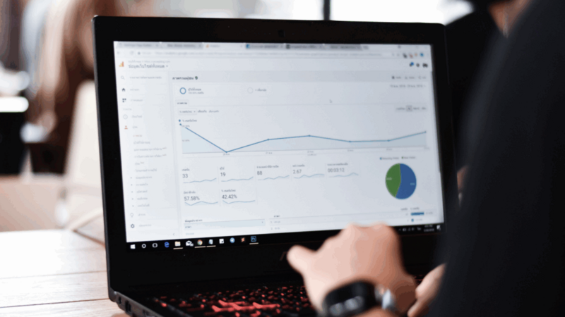 A close-up shot of a laptop screen with Google Analytics data displayed.