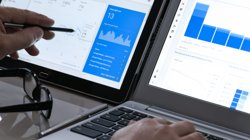A person working on a laptop displaying a graph, indicating data analysis or business performance.