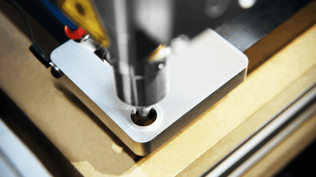 A close-up of a cutting machine slicing through a piece of wood, showcasing the sharp blade and wood shavings.