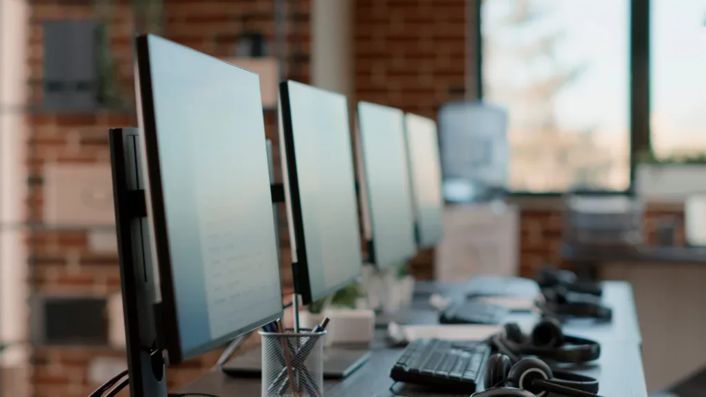 Three computer monitors arranged on a desk, showcasing a workspace setup for productivity and multitasking.