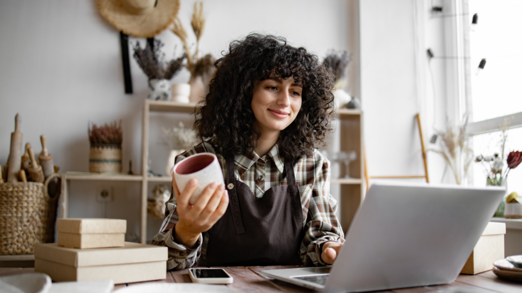 A woman looking at the laptop screen.