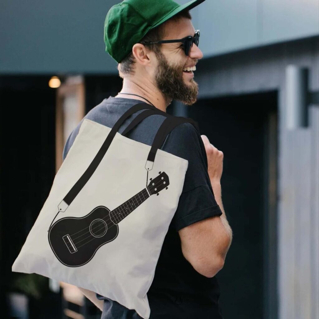 A tote bag with a design of a black guitar.