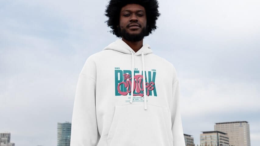 A man in a custom white hoodie with a logo print on the front.