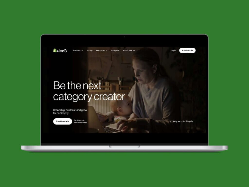 A screenshot of the Shopify hero section homepage on a laptop screen with a green background.